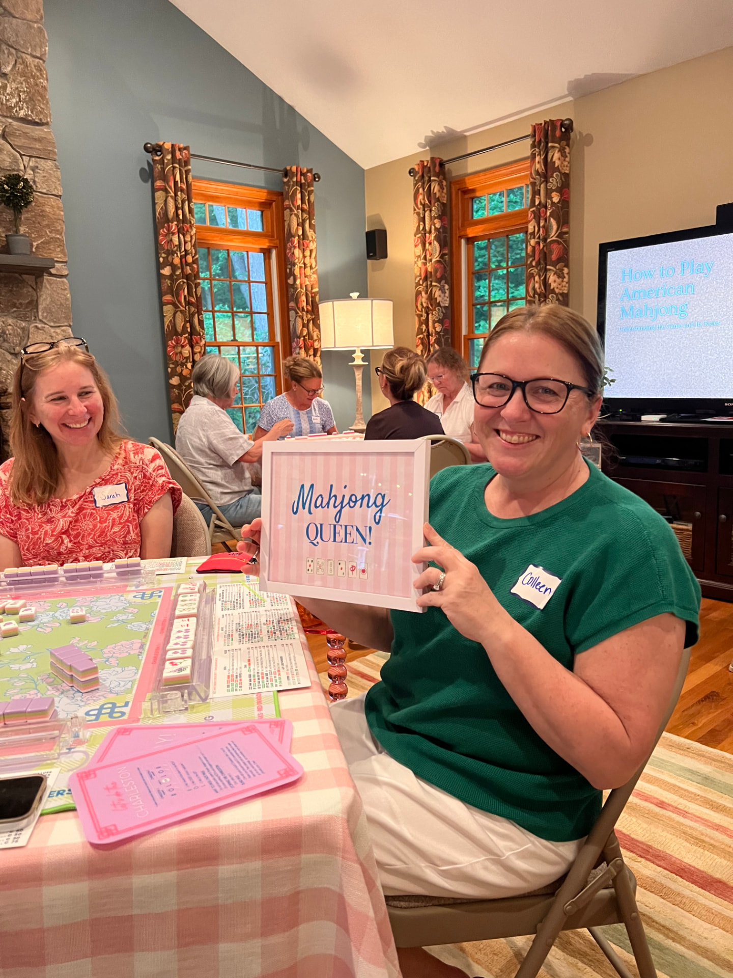 A beginner class player holding a Mahjong Queen sign at a Mahj with Sue lesson